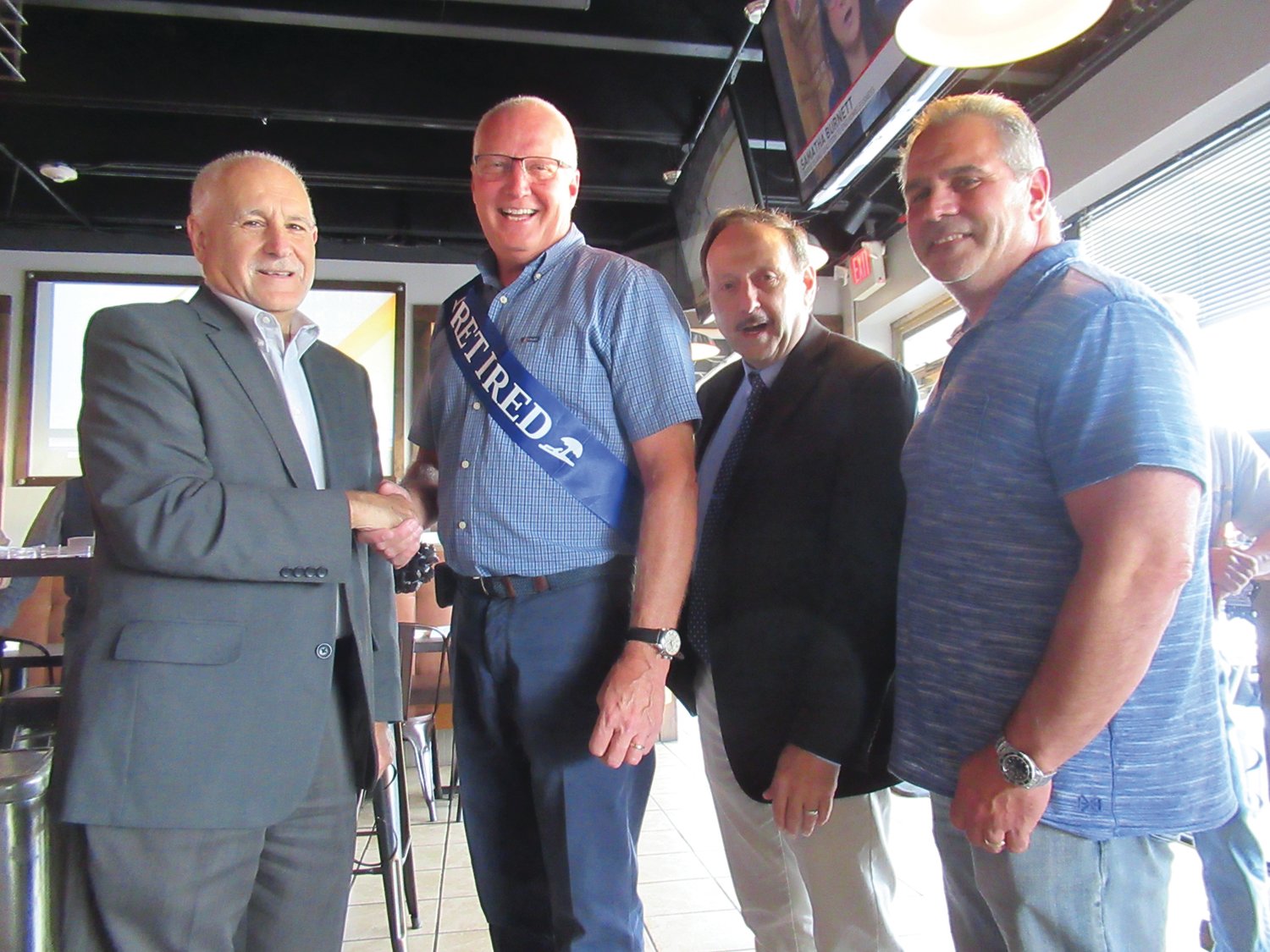 MAIN MAN: Johnston Mayor Joseph Polisena, joined by School Superintendent Dr. Bernard DiLullo and School Committee Vice Chairman Joseph Rotella, congratulates Dave Cournoyer on his retirement from the School Department, where he served with dignity and respect for all